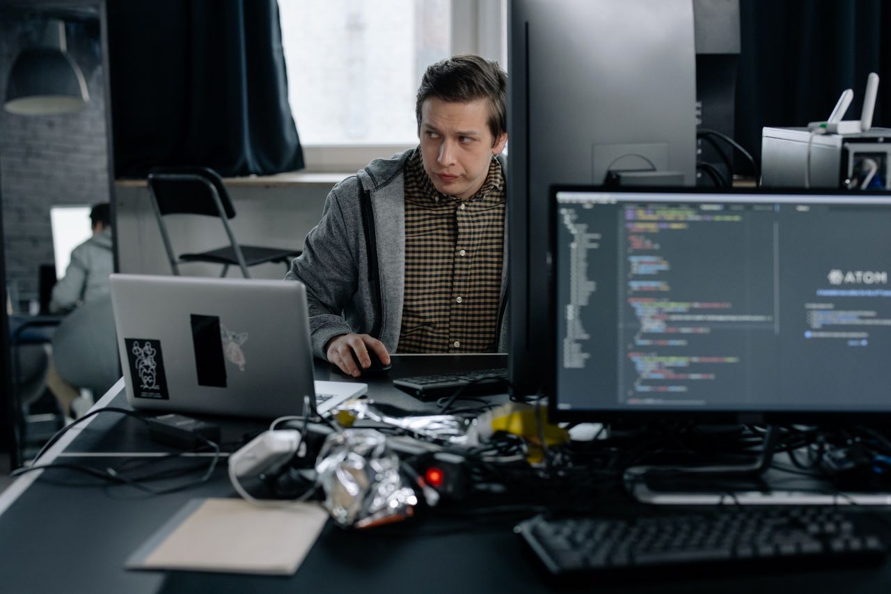 Crafting Captivating Headlines: Your awesome post title goes here A programmer in a modern office working on computer code, showcasing a focused work environment.